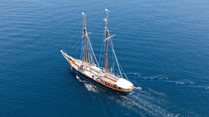 Obraz premium Aerial drone top down photo of classic wooden double mast sailing ship cruising in open ocean sea