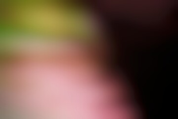Obraz premium Blurred image of vibrant pink and green hues with indistinct shapes creating an abstract visual