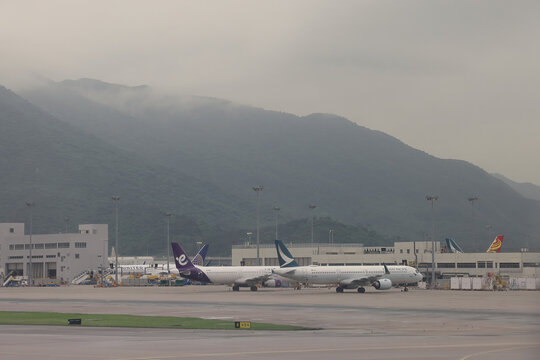 April 24 2026 Passenger Aircraft Parked At Terminal With Mountains