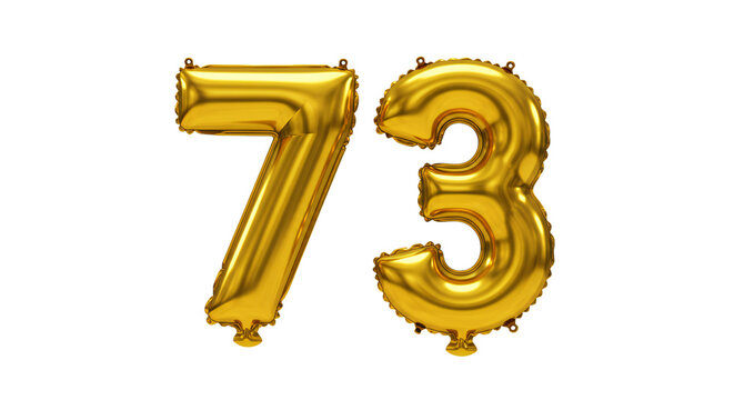A gold balloon displays the number seventy-three in a studio.