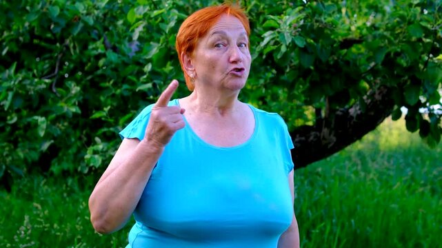 emotional grandmother gestures firmly and reacts with visible frustration while addressing someone off camera. Intense facial expressions and animated movements convey anger criticism.