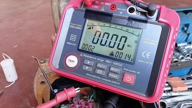 Close-up view of a digital insulation resistance tester screen during a diagnostic check on a faulty electric water pump motor.
