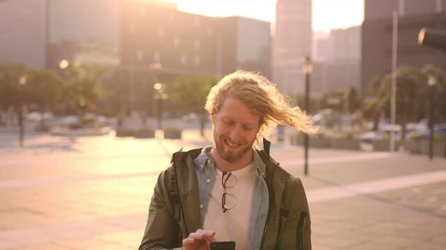 Man, smile and phone in city with sunset, scroll and social media browse online with internet. Outdoor, mobile app and connection with tech for communication, networking and text message to contact