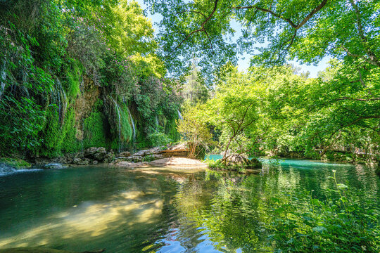 Scenic view of Kursunlu Waterfall and emerald water pond in Antalya nature park, Turkey.