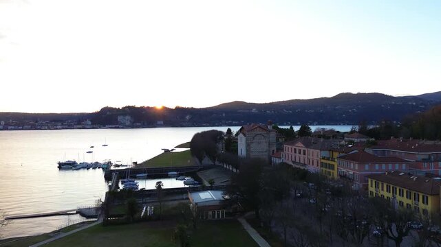 A drone view of the historic town of Angera and Lake Maggiore in Italy. Sunset. 