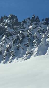 Dramatic snow-covered peaks in Livinallongo del Col di Lana, Dolomites. Rugged alpine landscape, untouched snowfields and breathtaking mountain scenery in the Dolomiti Superski region