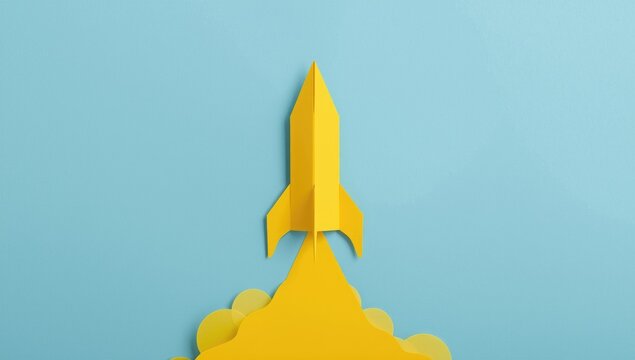 Yellow paper rocket silhouette against a soft blue textured surface with copy space