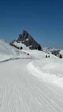 POV view from a skier descending a groomed ski slope near Cortina d&rsquo;Ampezzo in the Dolomites. Snow-covered mountain scenery, winter adventure and Dolomiti Superski experience