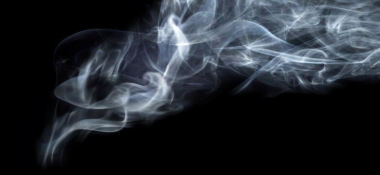 Abstract  white steam and smoke clouds isolated on black background. Dramatic swirling vapor textures with soft flowing shapes and atmospheric mist effect. 