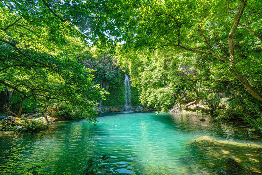 Scenic view of Kursunlu Waterfall and emerald water pond in Antalya nature park, Turkey.