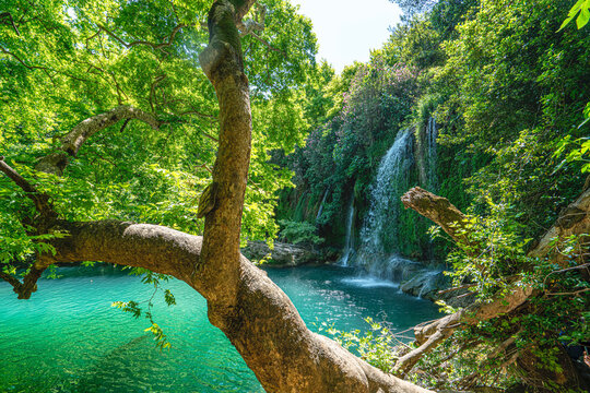 Scenic view of Kursunlu Waterfall and emerald water pond in Antalya nature park, Turkey.