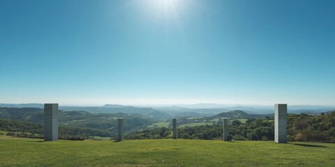 Fototapeta premium Simplified landscape design with green hills and vacant concrete pillars in a panoramic blue sky setting