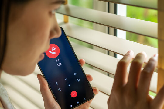 Woman calling emergency number 112 for crisis situation