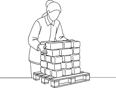 Worker lifting heavy stacked boxes on pallet indoors.