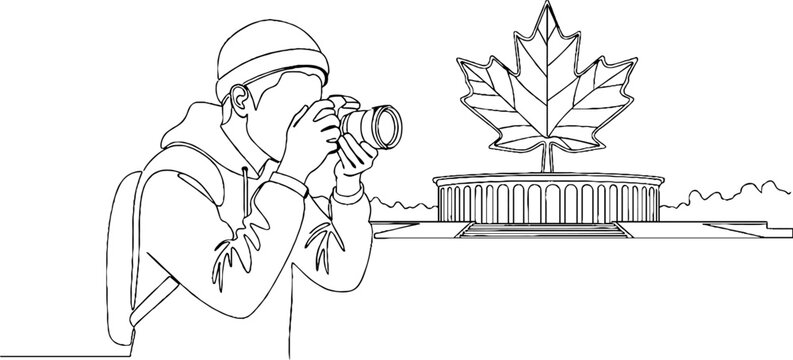 Tourist photographing iconic leaf shaped landmark from afar.