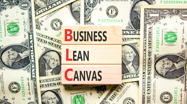 BLC business lean canvas symbol. Concept words BLC business lean canvas on beautiful wooden blocks. Beautiful dollar bills background. Dollar bills. BLC business lean canvas concept. Copy space.