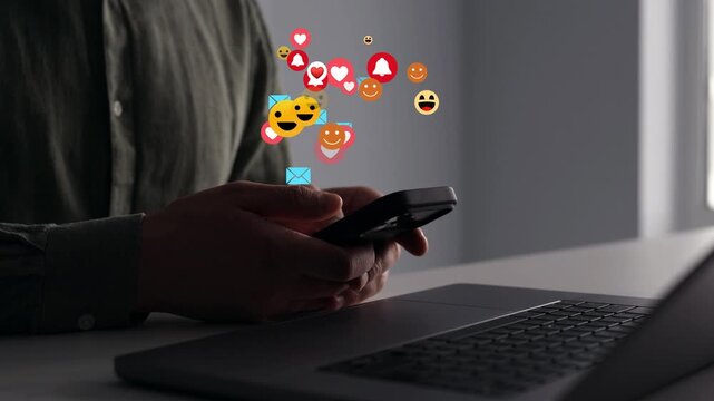 Man using smart phone with emoticon icons of Social Media.Interactive with friends on chat with emoticon feedback.Social media,marketing, like,social network,blog,live,chat reaction and livestream.	