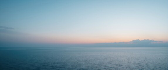 Fototapeta premium Still ocean vista under peaceful dusk sky with calm water and copy space area