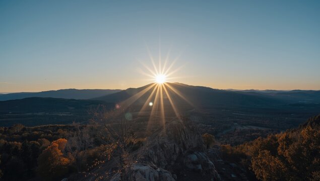 Radiant mountain sunrise in autumn with blue sky and copy space for design