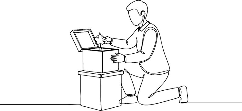 Young man using laptop on floor in workspace setup.