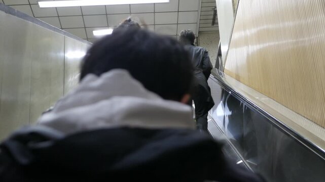 view of crowded passenger while using escalator going up to ground floor after subway train arrive to station,japan train public transportation