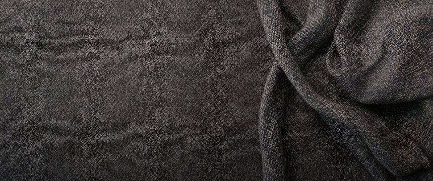 Overhead perspective of traditional clothing showcasing gray ulos textile detail as background with copy space