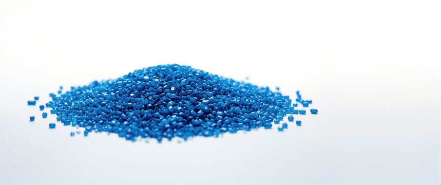 Pile of assorted blue plastic granules of different sizes on white base for material and design use