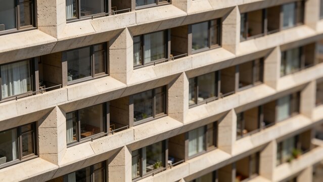 Generative AI depicts a modern concrete apartment building with multiple windows