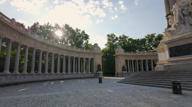 Colonnade in the pond of the Retiro Park where tourists gather to rest in Madrid.