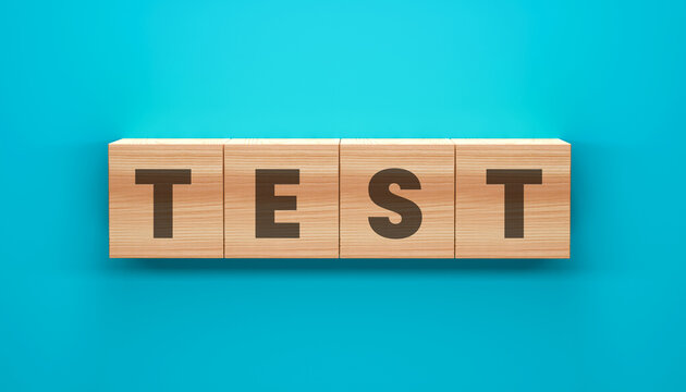 Test Written on Wooden Blocks: The word TEST is spelled out on four wooden blocks, each displaying a single letter, set against a vibrant turquoise background.