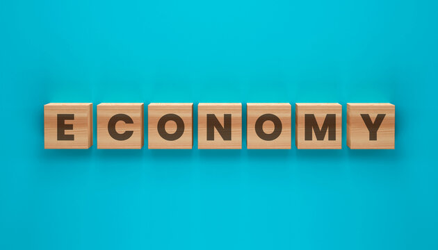 Economy Blocks: Wooden blocks spelling out ECONOMY are neatly arranged on a vibrant teal background, symbolizing financial systems and economic activity.