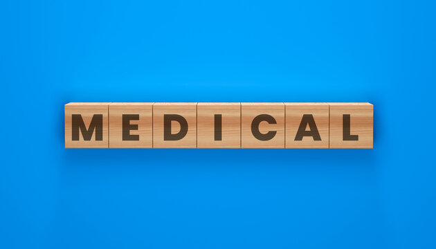 MEDICAL spelled on wooden blocks against a bright blue background