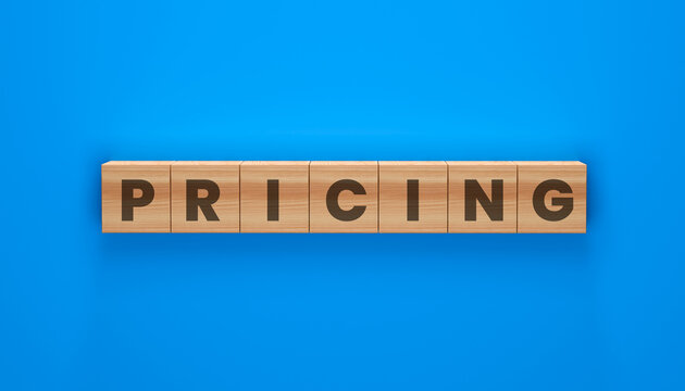 PRICING spelled out in wooden blocks on a blue background. A conceptual representation of cost, value, and market strategy.