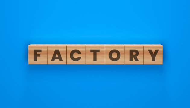Factory spelled out in wooden blocks on blue background