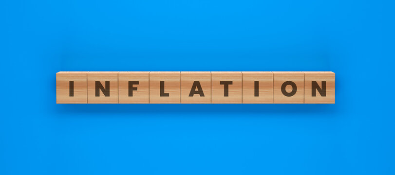 Inflation Word Blocks: The word INFLATION is spelled out with wooden letter blocks on a vibrant blue background, symbolizing economic instability and rising prices.