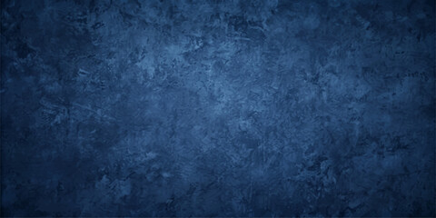 Obraz premium A dark, textured background in deep blue hues, reminiscent of aged concrete or stormy skies, provides a dramatic and brooding atmosphere for any design element.
