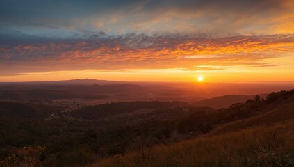 Obraz premium Sunset panorama showing peaceful valleys under glowing skies