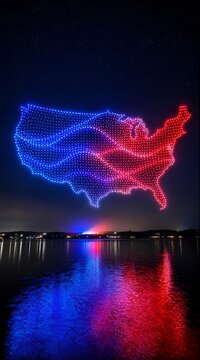Drone light show forming USA map over water at night with red and blue reflections for Independence Day celebration