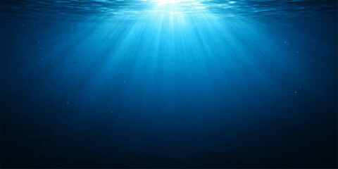 Obraz premium Sunlight pierces the deep blue ocean water, creating ethereal rays that illuminate the underwater world.