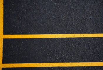 Fototapeta premium Asphalt road texture with yellow center lines