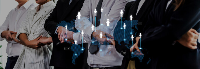 A corporate team stands united in an office, with a digital overlay depicting growth arrows on a global map, symbolizing unity and business progress. Trope © InfiniteFlow