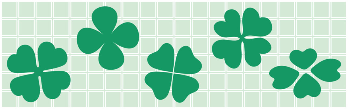 Vector of green clovers on a light green grid background.
