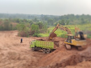 Fototapeta premium Land acquisition construction for housing development combine harvesting wheat
