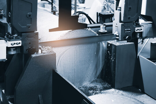 automatic band saw machine cutting metal bar with coolant method. machine tool for industrial purpose.