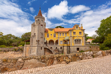 Obraz premium Historic villa with a stone tower in Cascais, Portugal.