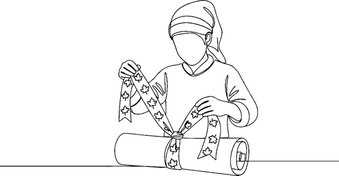 Person carefully wrapping decorative bows on a package.