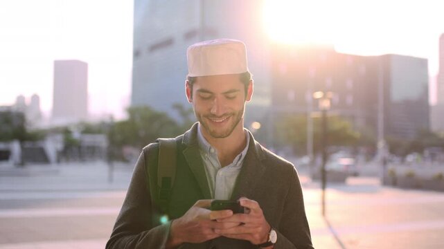 Business, laugh or Muslim man in city with phone, online chat or comic post on social media. Happy, Arab person or employee in town with flare, funny text message or meme reaction in travel routine.