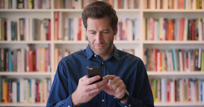 Face, phone and thinking with man in library as college or university professor for online education. App, future and learning with teacher in bookstore for academics, knowledge or mobile research