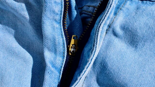 Close-up of a jeans zipper, revealing refined details and the quality of craftsmanship. Detalhe do z&iacute;per de cal&ccedil;a jeans, capturando a ess&ecirc;ncia da moda casual e urbana.