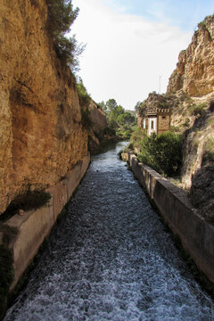 Water canal through a rocky gorge in Camarillas reservoir.